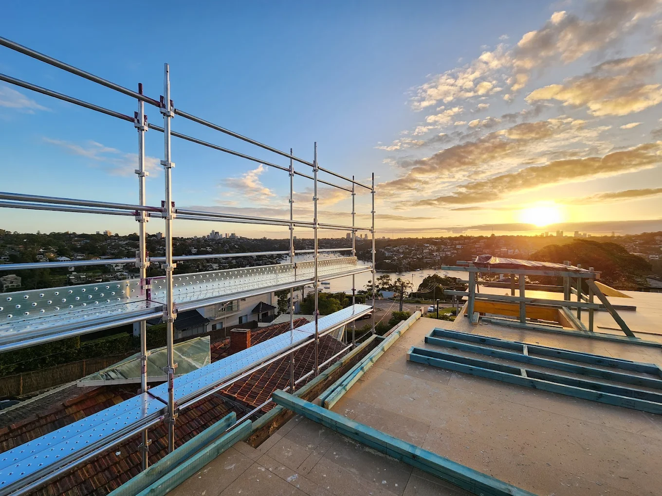Everest Scaffolding rooftop scaffold at sunset overlooking Sydney